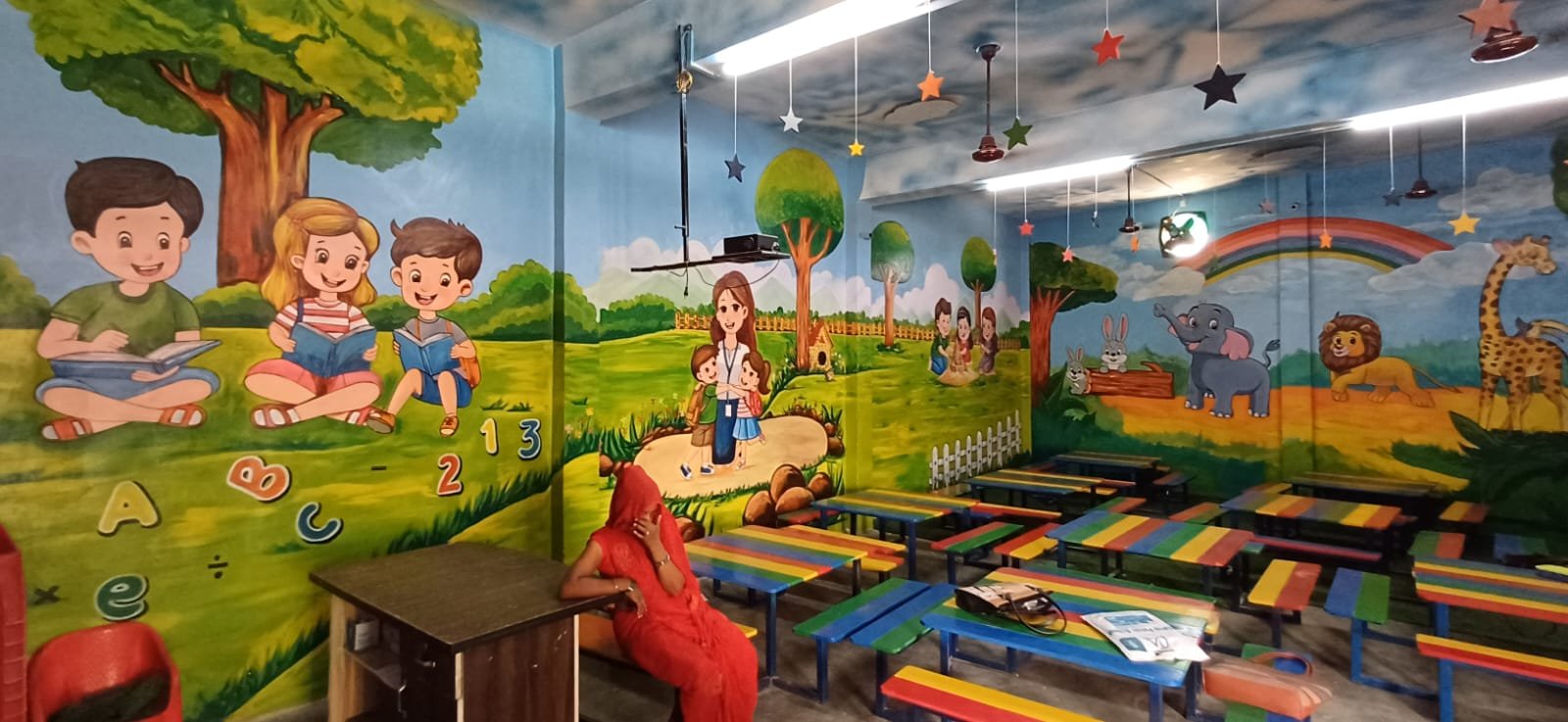 Colourful hand-painted educational murals inside a classroom
